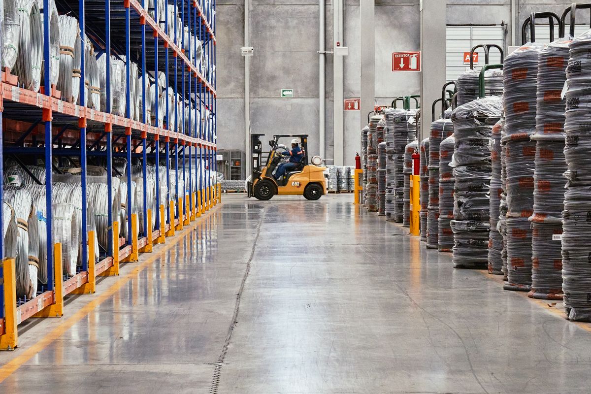 Forklift moving stock through a distribution warehouse